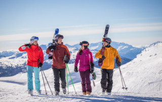 A mixed group of skiers and snowboarders